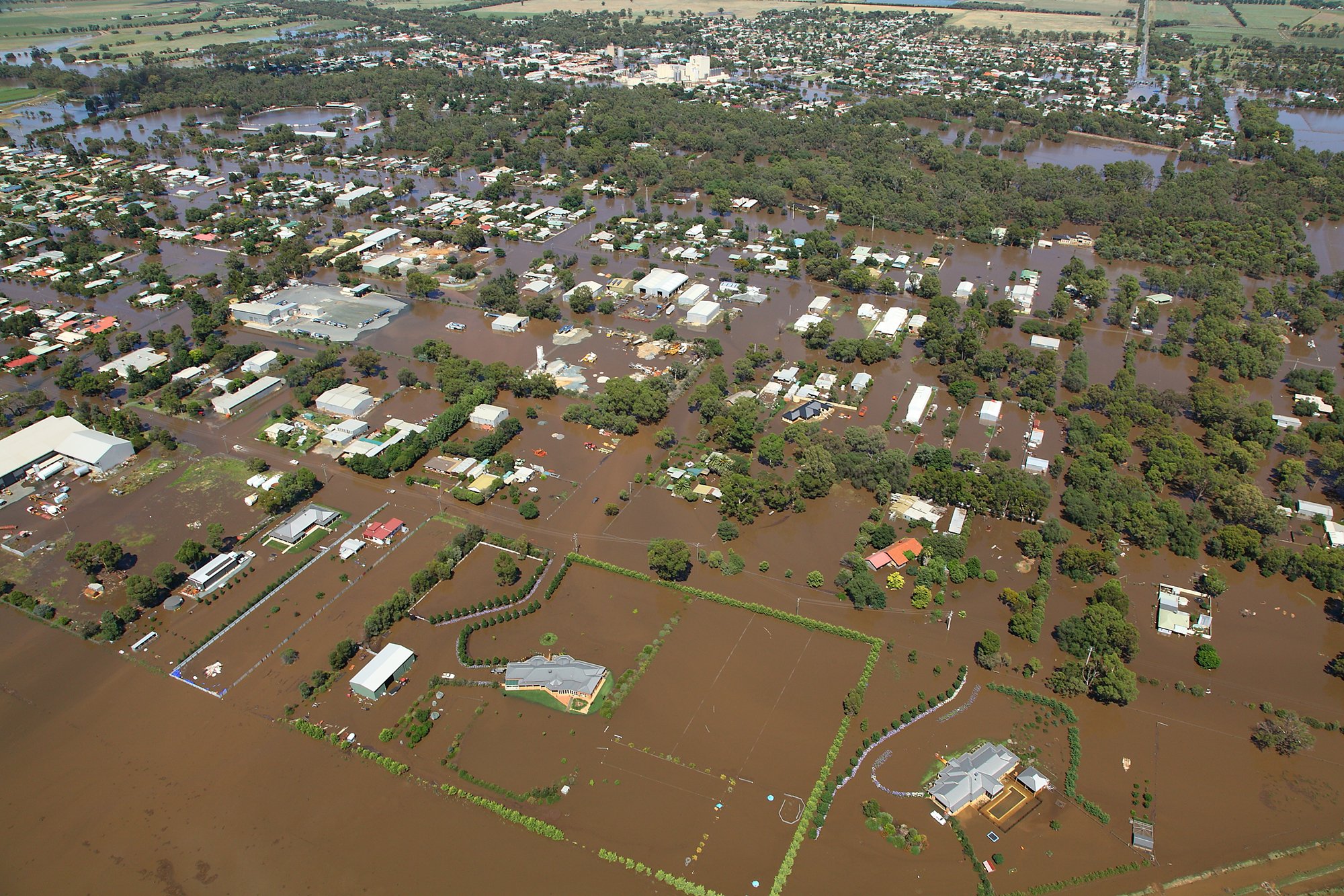 An aerial shot of a country town inundated with floodwaters.
